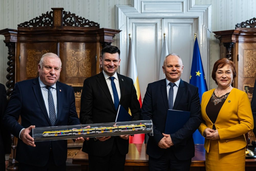 Zdjęcie grupowe gdzie pan Marszałek trzyma model pociągu.